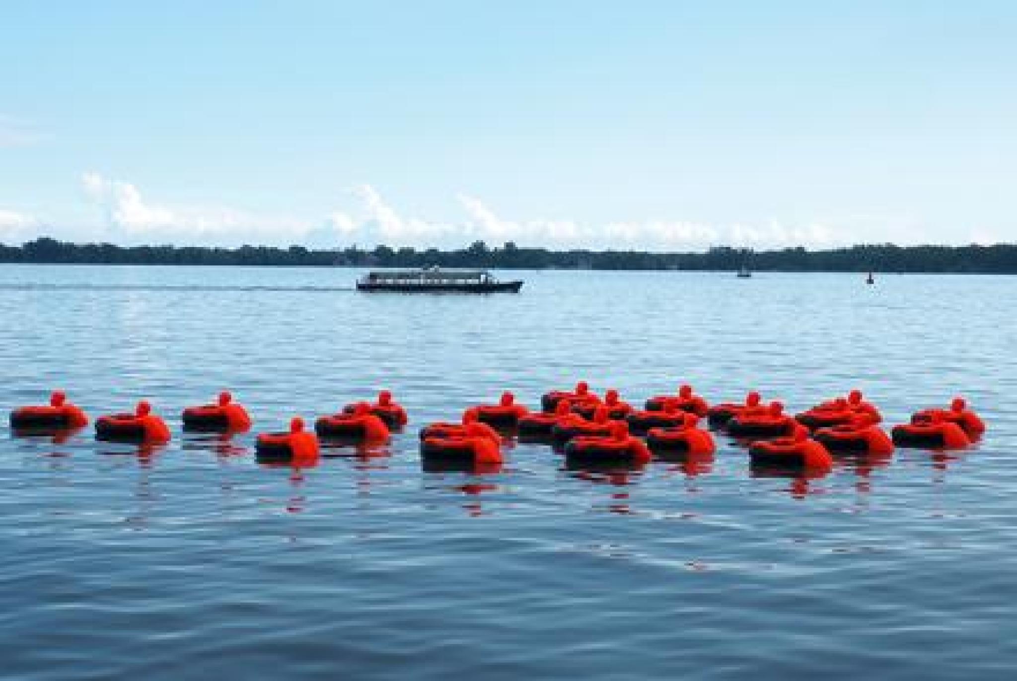 Image: 25 figures clinging to inner tubes. Each represents more than one million refugees in the world. James Beheshti (Unsplash)