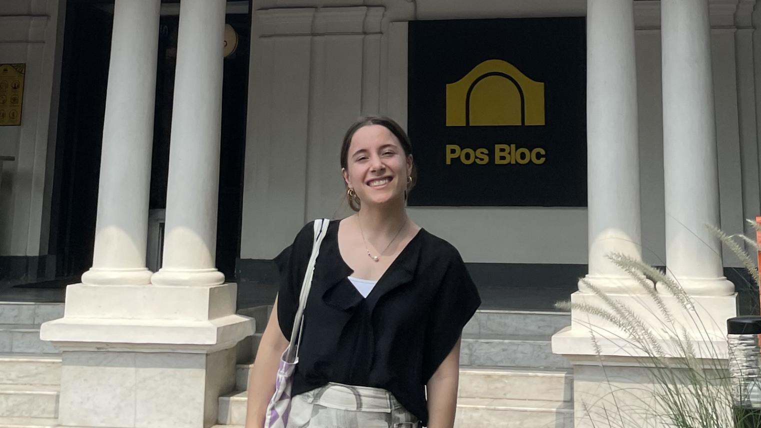 Midshot of Jayne Fendyk standing outside a white building in Indonesia