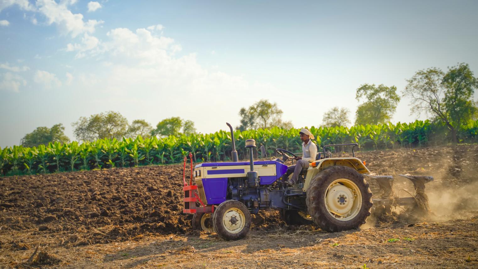 Farmer with tractor preparing land for sowing in India by PRASANNAPIX on Adobe Stock